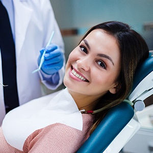 Woman smiling while visiting an implant dentist in Fairfax