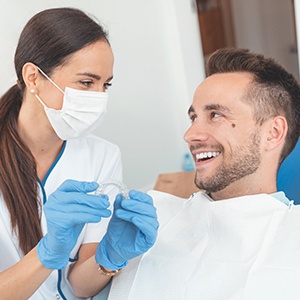 Dentist explaining cost of Invisalign in Fairfax to a patient