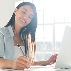 Smiling woman writing a note