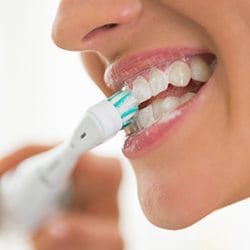 Closeup of patient brushing teeth