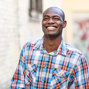 Man in plaid shirt smiling
