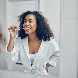 a person brushing their dentures