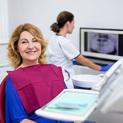 Woman learning about the cost of dentures in Fairfax.