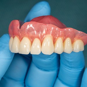 a person holding dentures in Fairfax