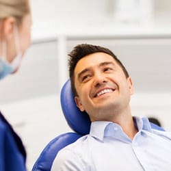 Smiling man during dental bonding treatment