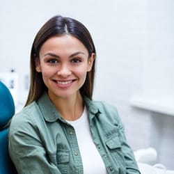 Smiling woman after dental bonding treatment
