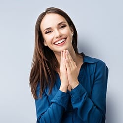 Smiling woman after tooth-colored filling restoration