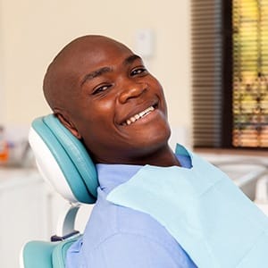 Man smiling after getting dental implants in Fairfax