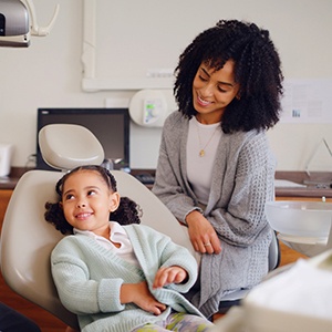 a mom and daughter speaking to a dentist 