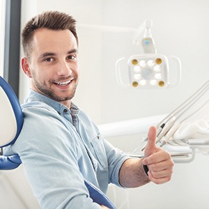 Man giving a thumbs up while visiting the dentist