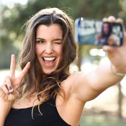 Woman taking a selfie after Invisalign treatment