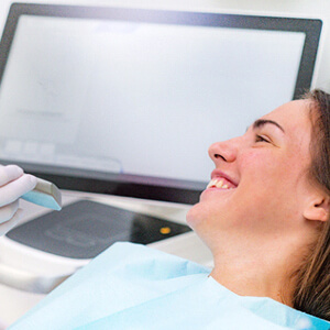 Patient smiling before getting teeth scanned with iTero scanner in Fairfax