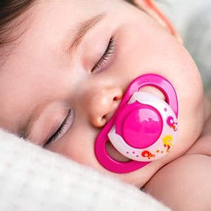 Baby sleeping with pacifier
