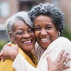 Smiling mother and daughter after periodontal pocket irrigation