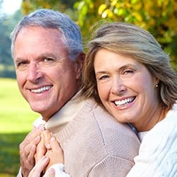 Smiling older man and woman outdoors