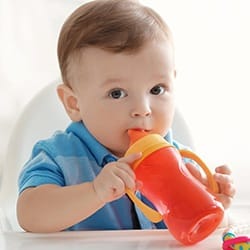 Little boy drinking from sippy cup