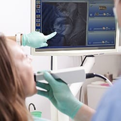 Dentist and patient looking at intraoral photos