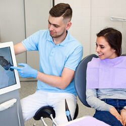 Dentist and patient discussing results of iTero scan
