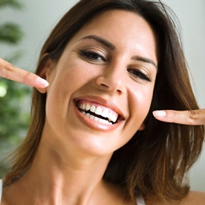 Woman smiling after teeth whitening in Fairfax