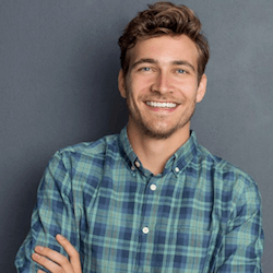 Man smiling after porcelain veneer treatment