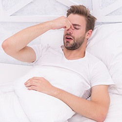 A man lying awake due to sleep apnea