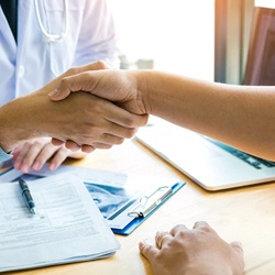 Dentist and patient shaking hands after teeth whitening in Fairfax, VA