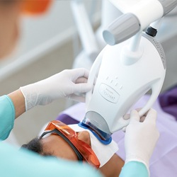 A patient receiving whitening treatment.