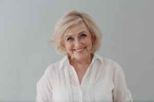 a woman smiling with dentures