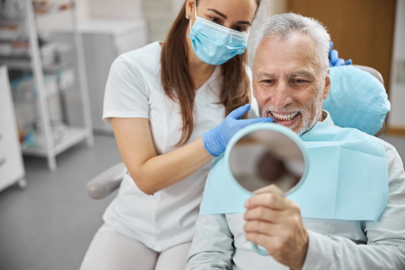 An aging man happy with his new dental implant