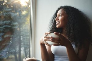 Woman smiling while drinking coffee