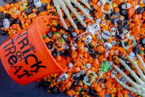 Halloween bucket tipped over a pile of candy
