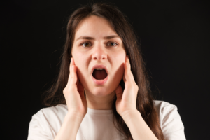 a person suffering from TMJ pain