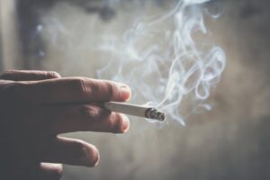 Person smoking a cigarette.